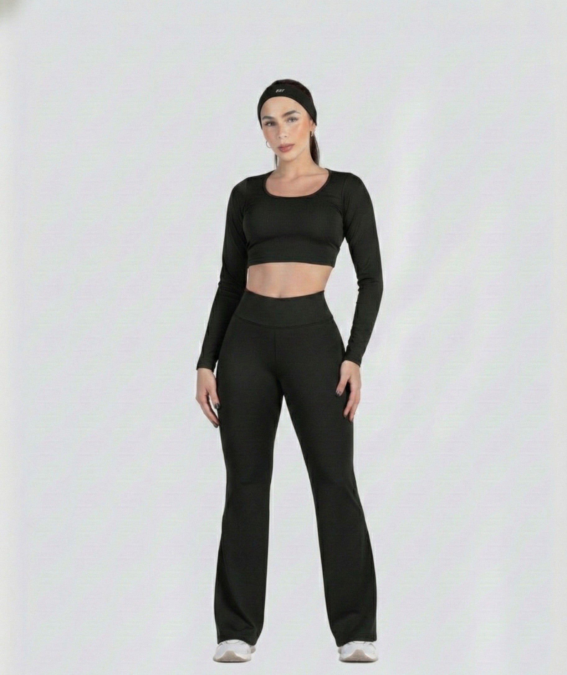 Woman wearing a black athletic outfit on a white background