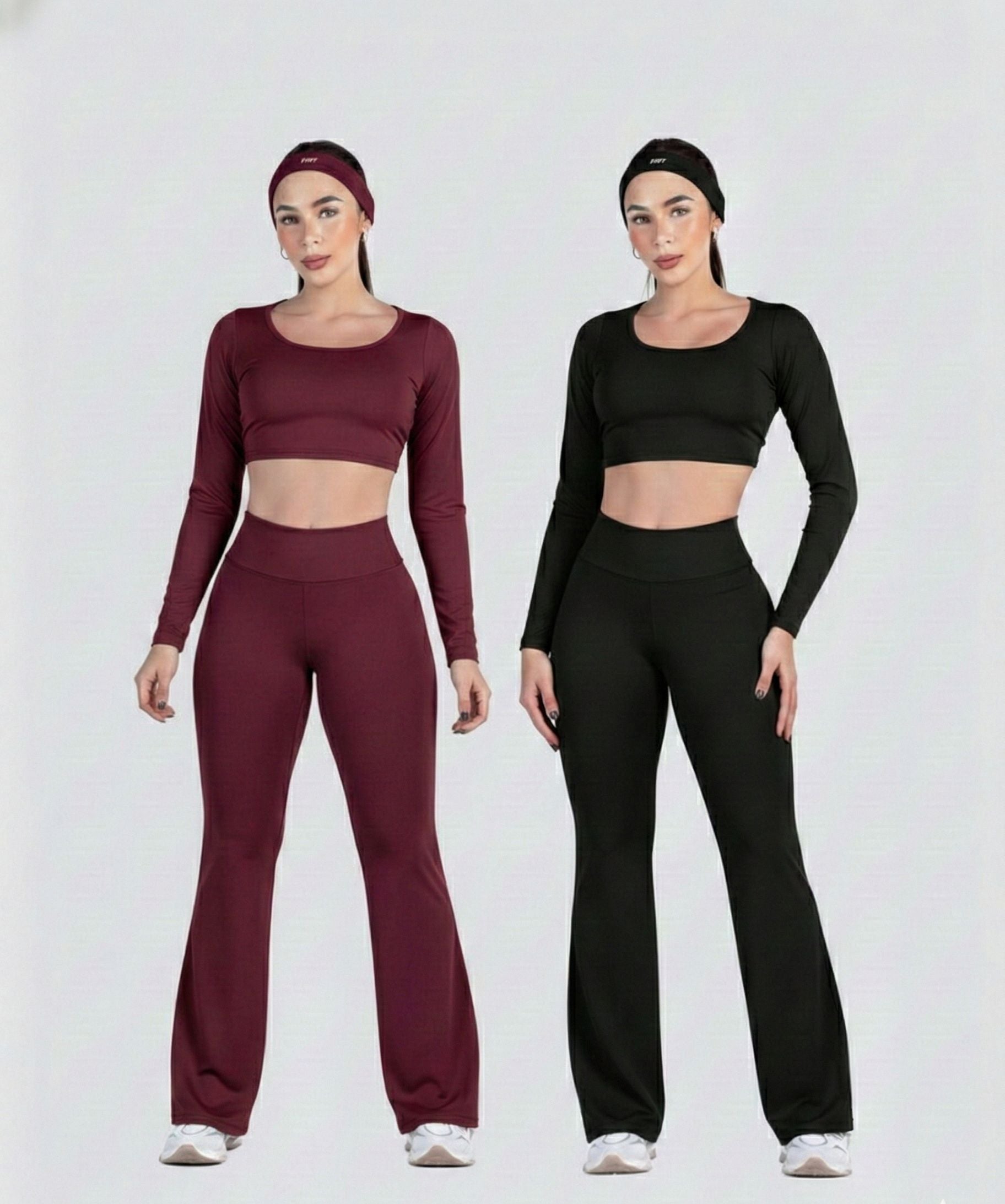 Two women wearing matching athletic outfits in maroon and black on a white background.