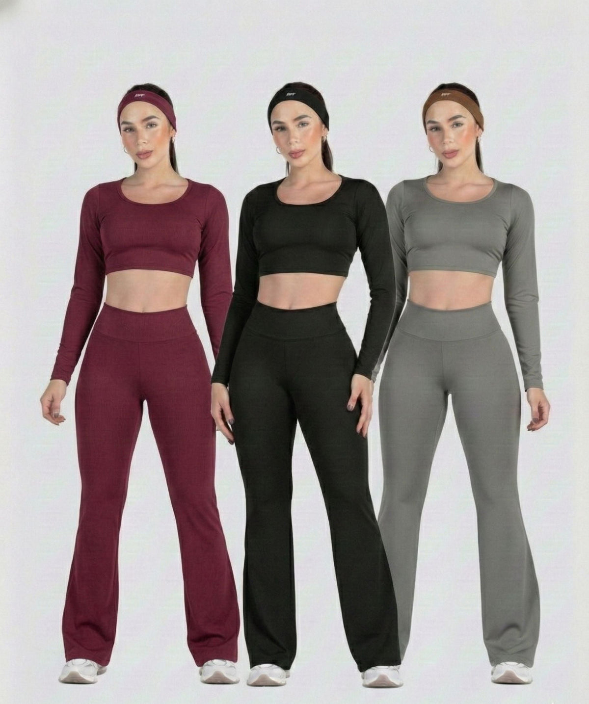 Three women wearing matching athletic outfits in red, black, and gray on a white background.