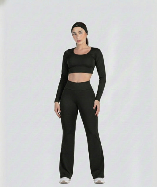 Woman wearing a black athletic outfit on a white background